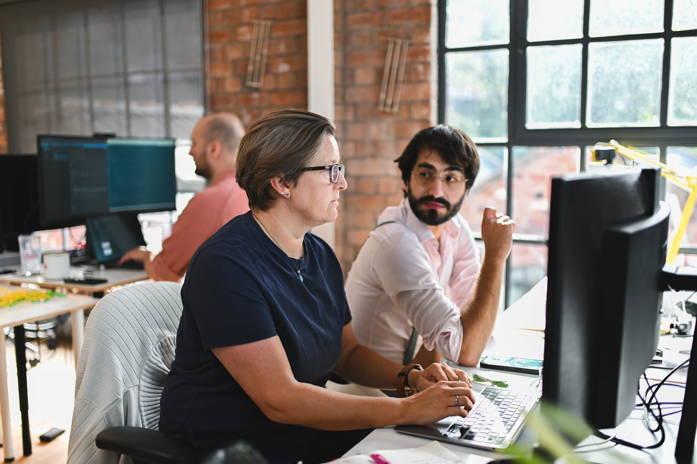 Man and woman working on a computer